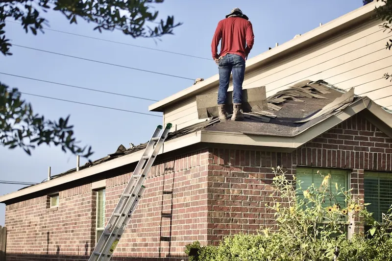 Professional roofer working on a residential roof in Sterling Valley